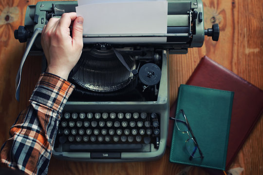 typewriter retro hand on wooden table