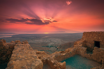 Beautiful sunrise over Masada fortress. Ruins of King Herod's palace in Judaean Desert.