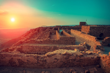 Beautiful sunrise over Masada fortress. Ruins of King Herod's palace in Judaean Desert.