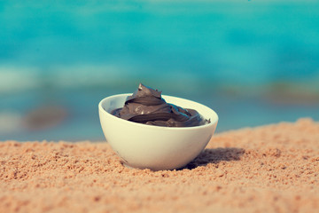 Dead Sea mud in a bowl on the beach