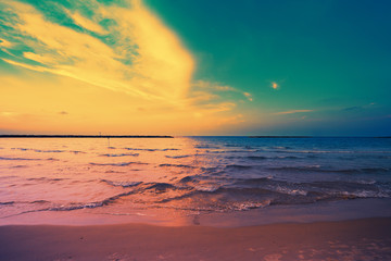 Early morning, sunrise over sea. Blue pink beautiful sunrise. Twilight time on the beach. 