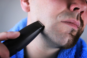 bearded man shaving