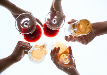 Friends clinking glasses with drinks, below view