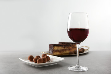Red wine and chocolate dessert on grey table