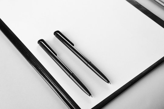 Closeup of pens on clipboard