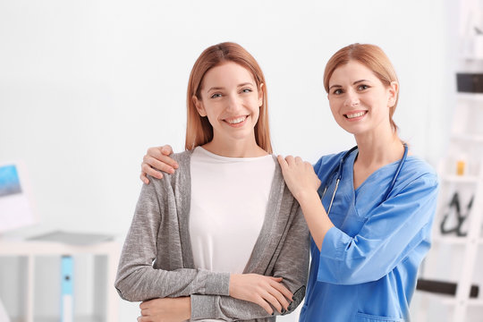 Beautiful Young Doctor And Patient In Clinic