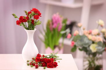 Beautiful roses in vase on table