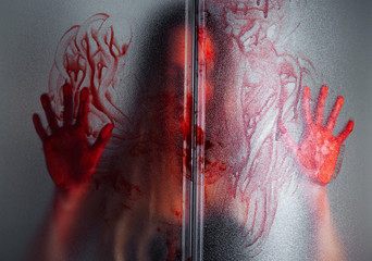 Woman in blood behind shower glass