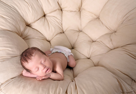 Cute little baby sleeping on lounge at home