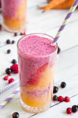 Rainbow smoothies, orange and purple in glasses