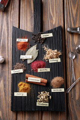 Different spices on wooden board