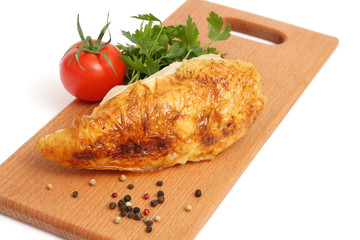 Grilled chicken fillet with tomato on wood