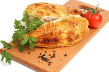 Grilled chicken fillet with tomato on wood