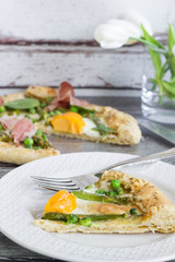 A slice of homemade spring galette, vertical.