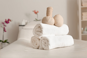 Fototapeta na wymiar Towels with herbal bags in spa center
