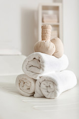 Towels with herbal bags in spa center