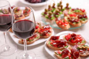 Wine with tasty bruschetta served on table