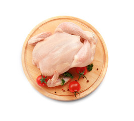 Cutting board with raw chicken and tomatoes on white background