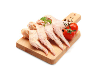 Wooden board with fresh raw chicken wings on white background