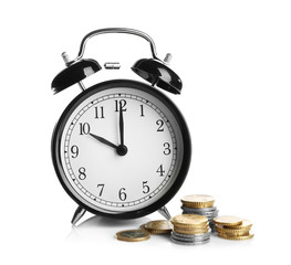 Alarm clock and coins on white background