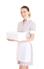 Attractive chambermaid holding pile of clean towels on white background