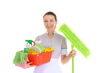 Beautiful chambermaid with cleaning equipment on white background