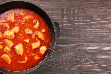 Chicken tikka masala in pan on wooden table