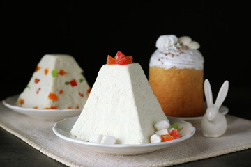 Traditional curd Easter cake with candied fruits on black background