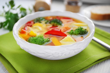 Bowl with vegetable soup on green napkin