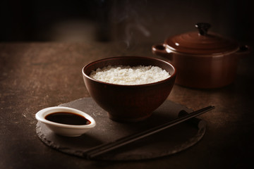 Steaming rice in a bowl on kitchen table