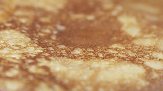 Slow motion of caramel sauce pour over blini closeup, 180fps prores footage