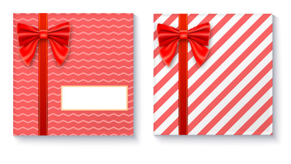 Gift boxes with big red bow and ribbon, isolated on white background. Top view on gift packaged in a paper with pattern and copy-space place for your text
