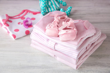 Pile of baby clothes on wooden table