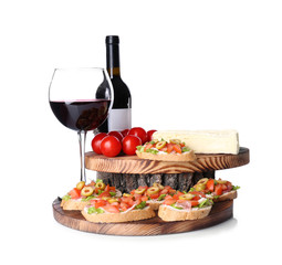 Tasty bruschetta served with wine on white background