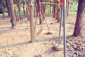 Fototapeta premium Children swing,playground in the park (vintage tone)