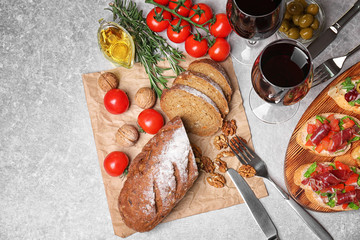 Tasty bruschetta served with wine on gray background