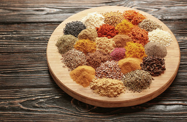 Different spices on wooden board