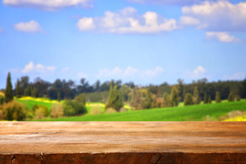 Empty rustic table in front of countryside