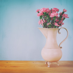Bouquet of Carnation flowers in the vintage white vase