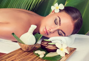 Zelfklevend Fotobehang Body care. Spa body massage treatment with hot  herbal ball for deep relaxation . Woman having massage in the spa salon  © Sofia Zhuravetc