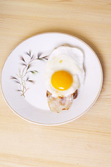 Fried egg with bacon and toast