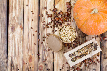 Cedar nuts, cones and pumpkin on wooden table