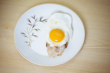 Fried egg with bacon and toast