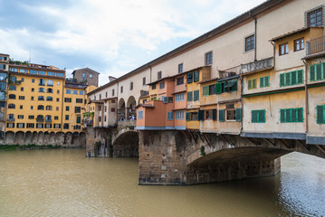 Fototapeta na wymiar Famous Ponte Vecchio bridge across the river Arno in Florence, Italy