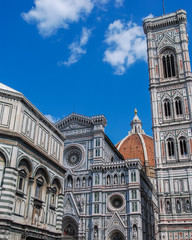 Fototapeta premium Florence cathedral with iconic duomo and white and green marble facade and clear blue sky