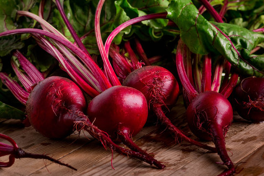 Organic Beetroot. Dark Red Beetroot on wooden background. 