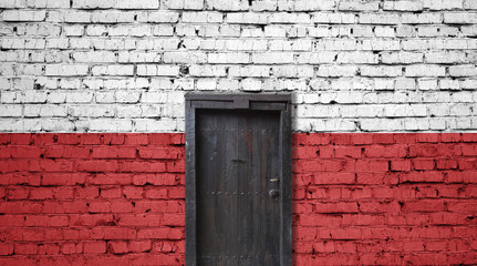 Poland flag on brick wall. Closed door in a wall