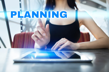 Woman is using tablet pc, pressing on virtual screen and selecting planning.