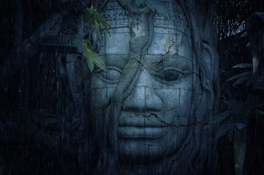 Fototapeta Ancient face at a mysterious ruins in jungle