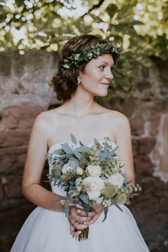 Portrait of young bride holding bouquet 